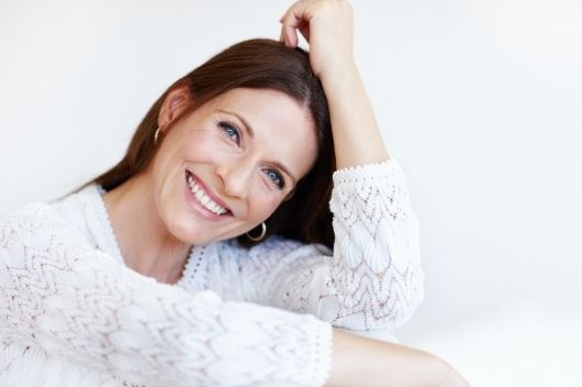 A woman smiling with dental implants in Pontefract