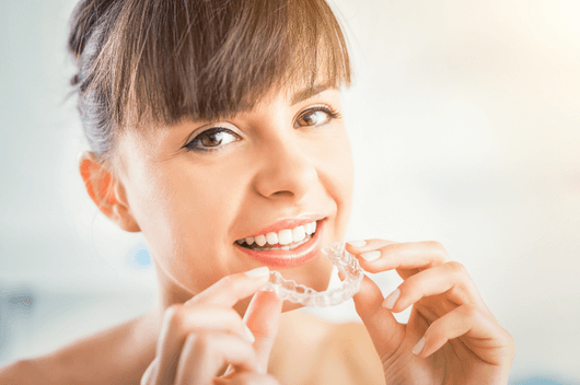 Woman smiling with Invisalign braces