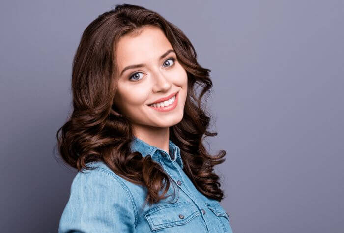 Woman smiling, wearing invisible braces