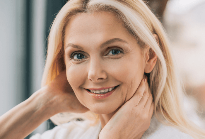 Older lady smiling after getting dental implants